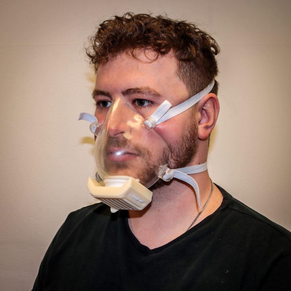 The Harbec mask is an injection molded clear mask. It features a reusable filter cartridge with MERV-15 material within a curved corrugated cassette to maximize breathability and filtration. 