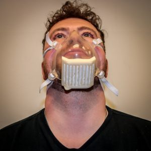 The Harbec mask is an injection molded clear mask. It features a reusable filter cartridge with MERV-15 material within a curved corrugated cassette to maximize breathability and filtration.